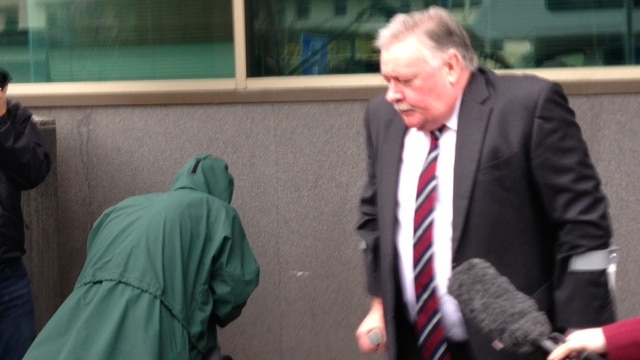 Ellis leaves court after pleading not guilty to a charge of causing death by negligent driving.
