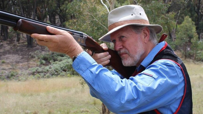 Robert Borsak MLC holding a gun as he prepares to take part in a Clay Target Game Club