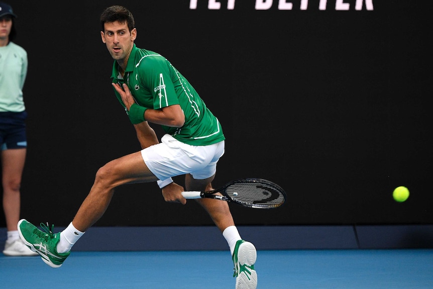 A male tennis players plays a shot between his legs at the Australian Open.