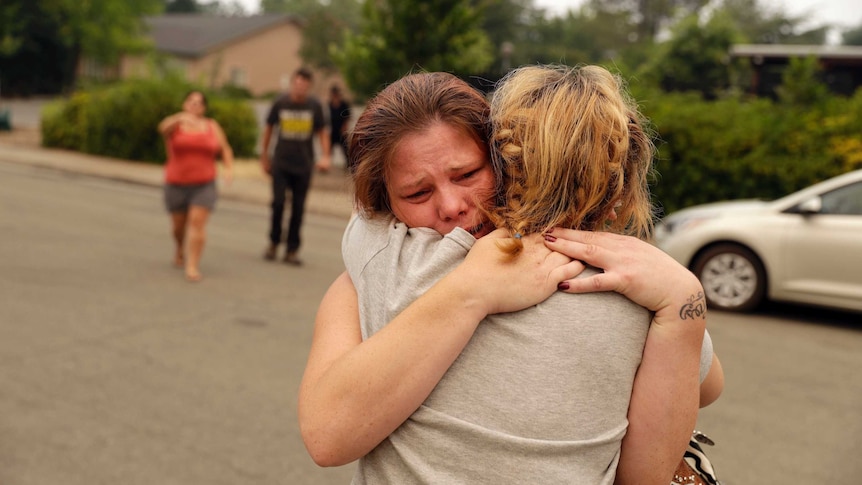 Carla Bledsoe, facing camera, hugs her sister Sherry outside of the sheriff's office.