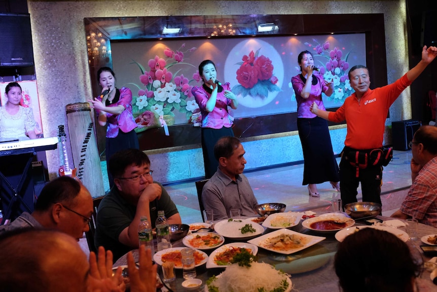 A South Korean man dances to a North Korean girl band.