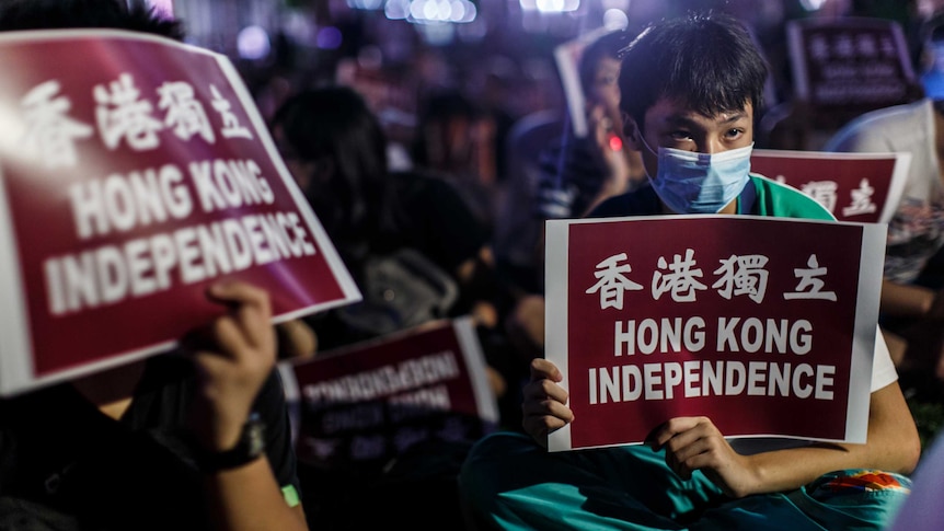 Protesters hold placards reading "Hong Kong Independence".