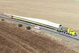 An aerial shot of two trucks carrying two wind turbine blades along the Barrier Highway.