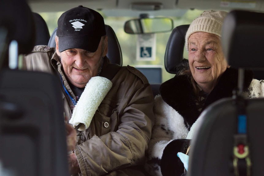 Bev Howlett and a resident of her hostel in the back of a bus to the local shops.