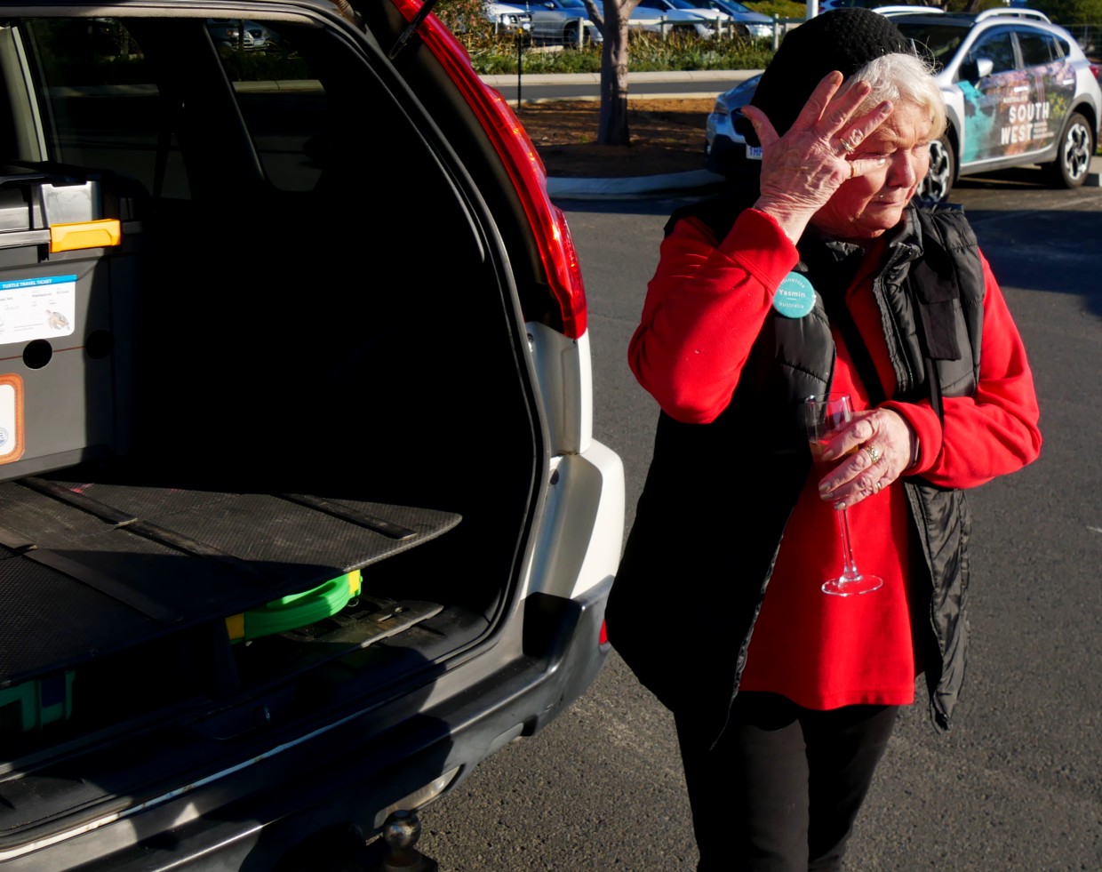 A woman wipes a tear from the eye