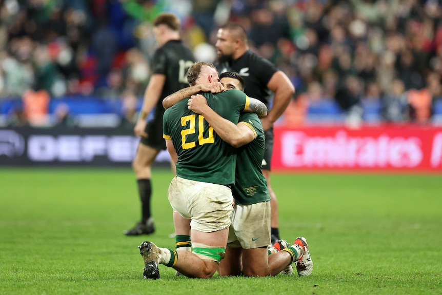 Two Springboks players embrace as they celebrate Rugby World Cup final win.