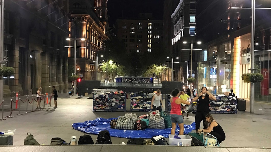 War on Waste production team building fashion pile in Martin Place, Sydney, at night.