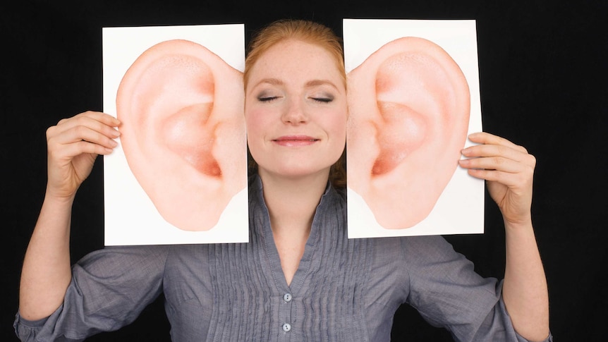 girl smiling and listening with huge comedy ears