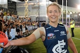 Lauren Arnell celebrates with fans after inaugural AFL Women's match