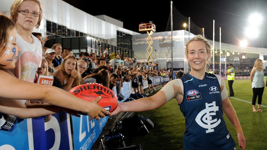 Lauren Arnell celebrates with fans after inaugural AFL Women's match