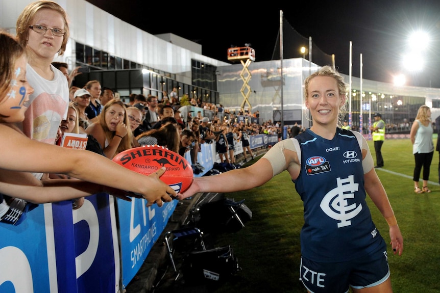 Lauren Arnell celebrates with fans after inaugural AFL Women's match