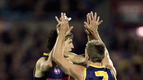 Adelaide's Kurt Tippett is congratulated on one of his six goals by team-mate Nathan Van Berlo.