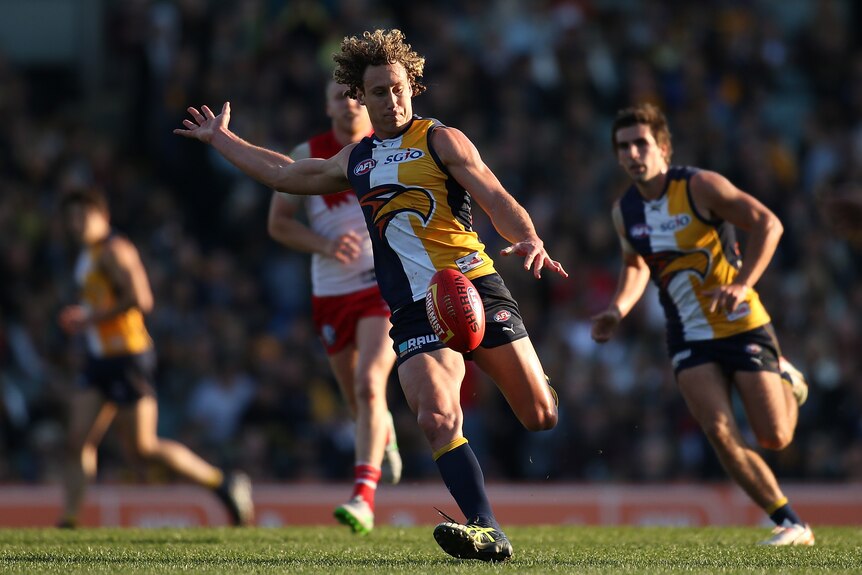 West Coast's Matt Priddis kicks the ball against Sydney in round 17, 2015 at Subiaco Oval.