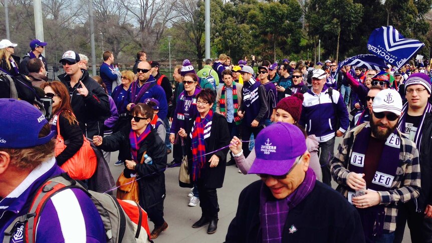 Fremantle Dockers fans create a sea of purple as they head towards the Melbourne Cricket Ground