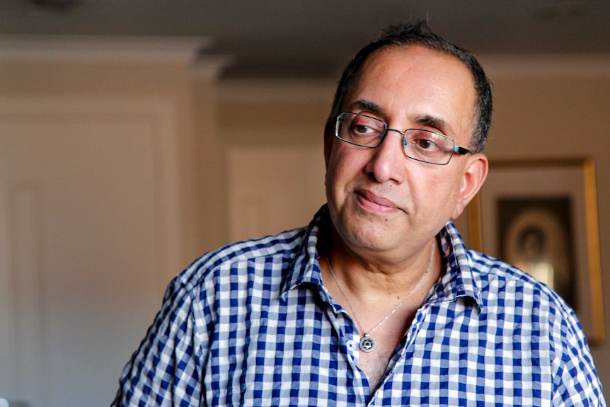 Ken Daniels stands in kitchen of his Melbourne home.