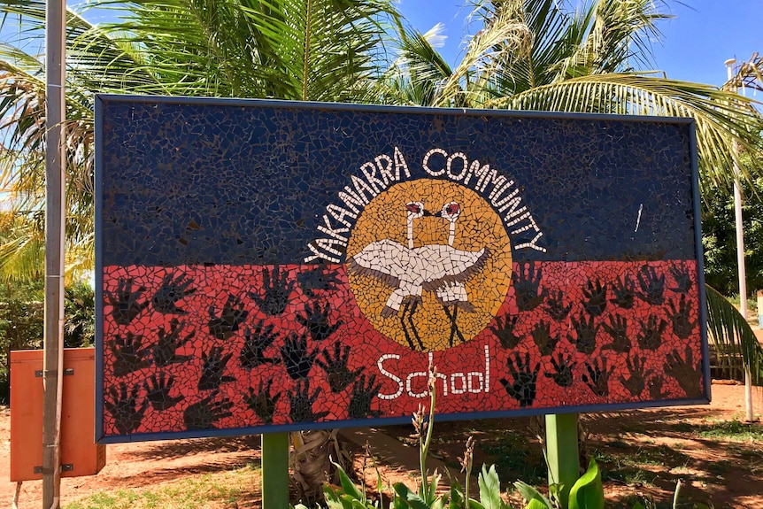 Exterior of Yakanarra School, sign with name and trees
