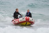 A father and son in a rescue boat.
