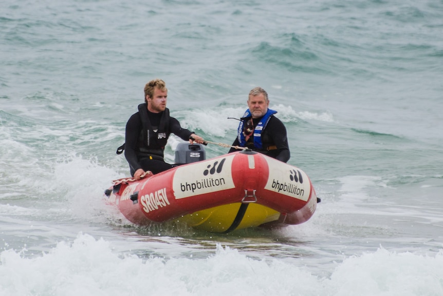 Two men in a rescue boat.