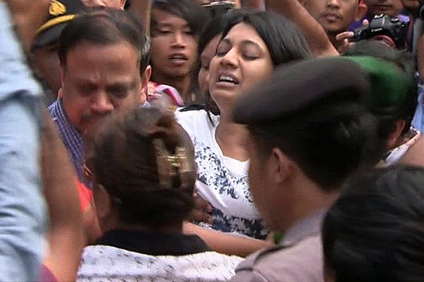 The sister of Myuran Sukumaran is carried through the media scrum.
