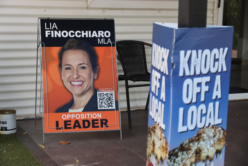 A woman's political advertisement is pictured behind an ad for an iced-coffee brand with the headline, Knock Off A Local.