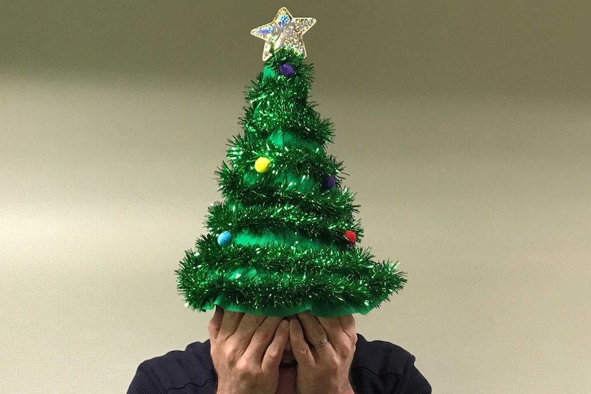 Upset person with a Christmas hat on.