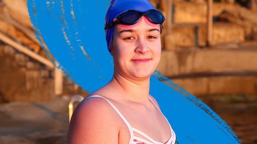 Young female swimmer in bathers, goggles and cap at Wylie's Baths seaside pool for a story about the health benefits of swimming