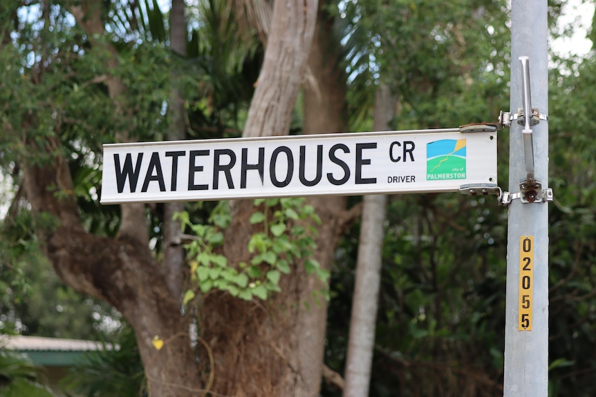 A street sign reading 'Waterhouse Cr', with trees in the background.