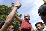 A monk is lifted in the air by a crowd chanting anti-government slogans in Rangoon. (File photo)