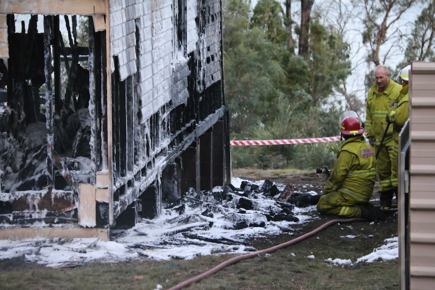 Firefighters investigating a shack fire