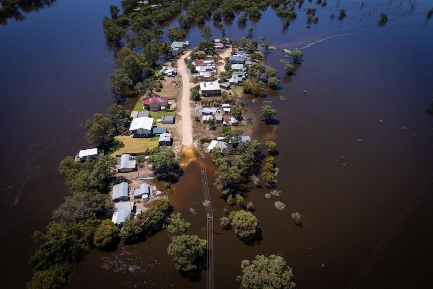 houses and a road flooded from a river