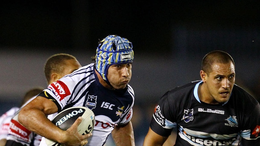 Star of the show... Johnathan Thurston makes a break at Shark Park.