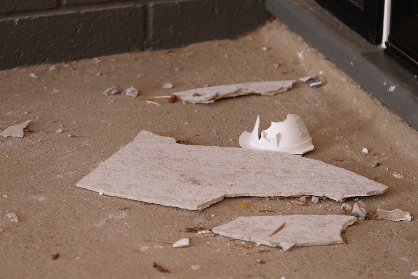 pieces of ceiling and light fixture on ground