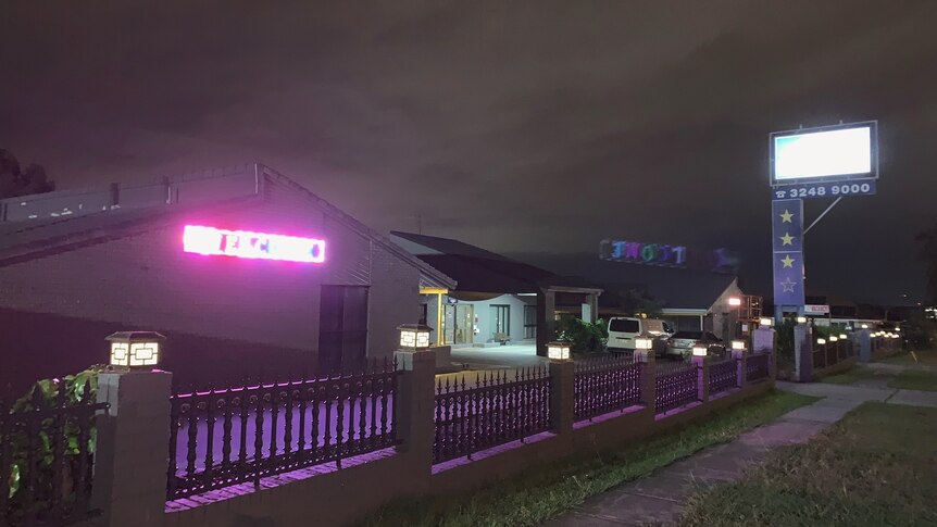 The exterior of Oxley Motor Inn at night