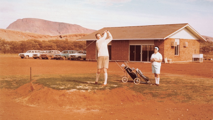 A man swinging a golf club.