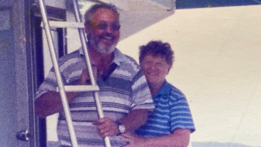 Alwyn and Jenny Rogash in an old picture smiling together beside a ladder.