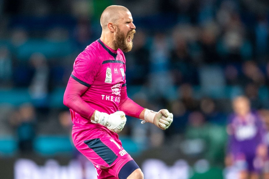 A Sydney FC A-League player screams out in celebration following a goal against Perth Glory.