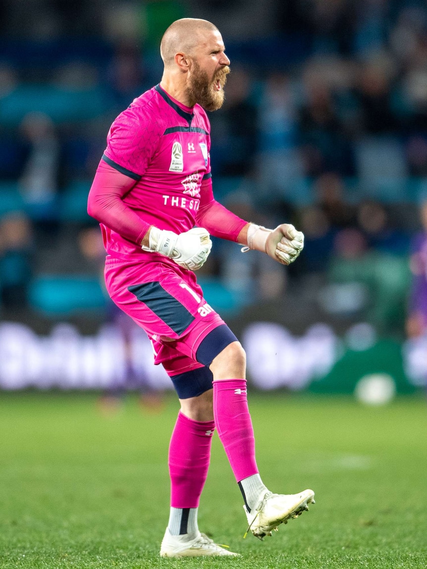 A Sydney FC A-League player screams out in celebration following a goal against Perth Glory.