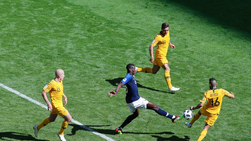 France's Paul  Pogba and Australia's Aziz Behich clash for the ball
