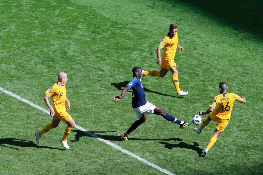 France's Paul  Pogba and Australia's Aziz Behich clash for the ball