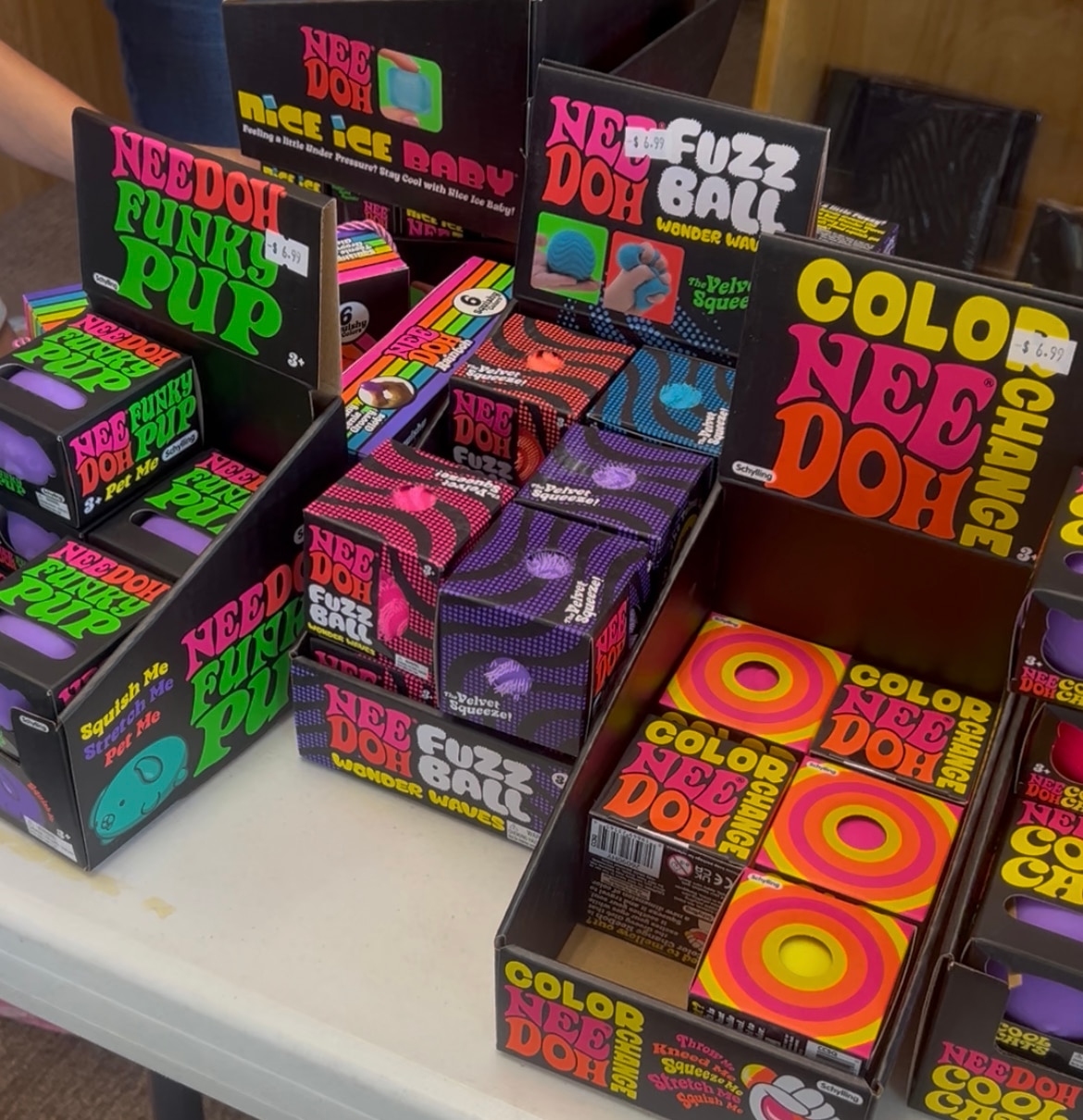 Needoh cubs in boxes on a store shelf.