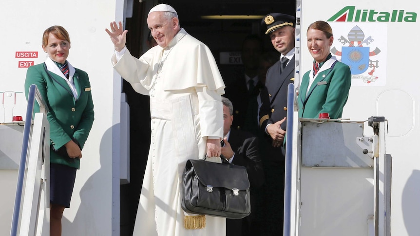 Pope Francis waves as he boards a plane at Fiumicino Airport in Rome September 19, 2015