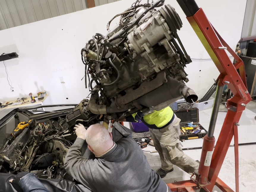 Engine being removed from DeLorean