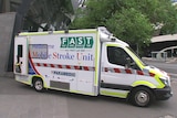 The stroke ambulance parked in the street.