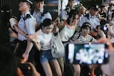 People in Hong Kong protest as police move in.