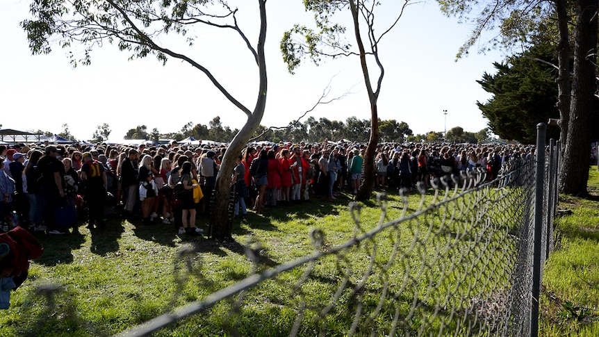 Thousands of people line up outside the gates of Lucindale's One Night Stand waiting to get in.