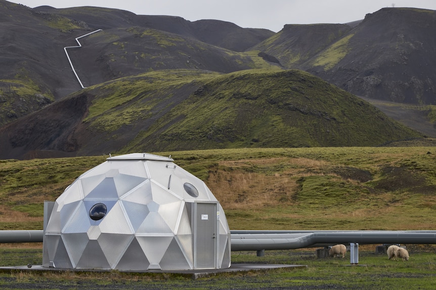 A silver geodesic dome in a barren landscape