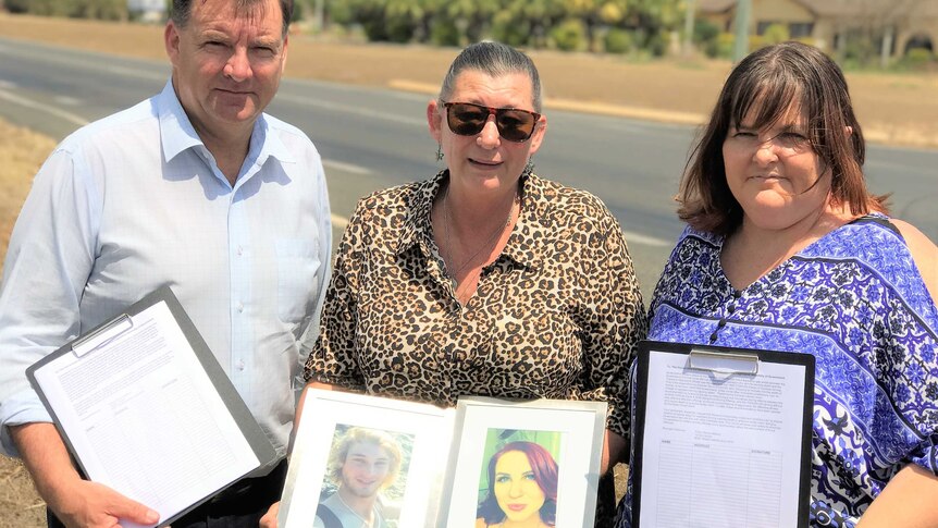 Stephen Bennett, Kerri Walker and Trisha Mabley holding photos of Daniel and Sarah and copies of the petition.