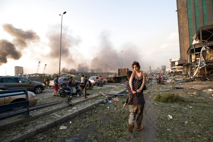 Dozens of people evacuate the wounded after a massive explosion in Beirut.