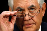 Rex Tillerson adjusts his glasses during the confirmation hearing.