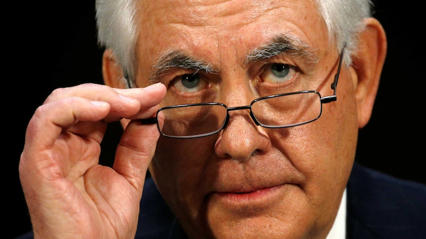 Rex Tillerson adjusts his glasses during the confirmation hearing.